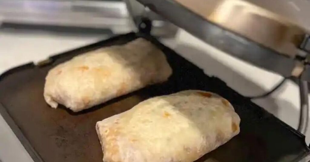 Press the burritos in a sandwich press